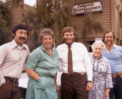 Gert and Tim Boyle with family and friends in front of the Columbia Sportswear headquarters from the 1970s.