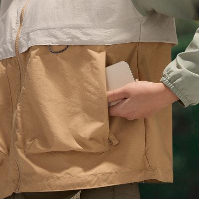 Model slipping a phone into their front pocket.